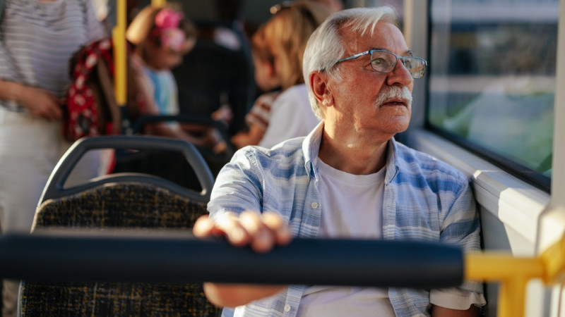 Homme senior assis dans bus