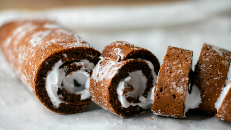 Chocolate swiss roll cake with white cream filling