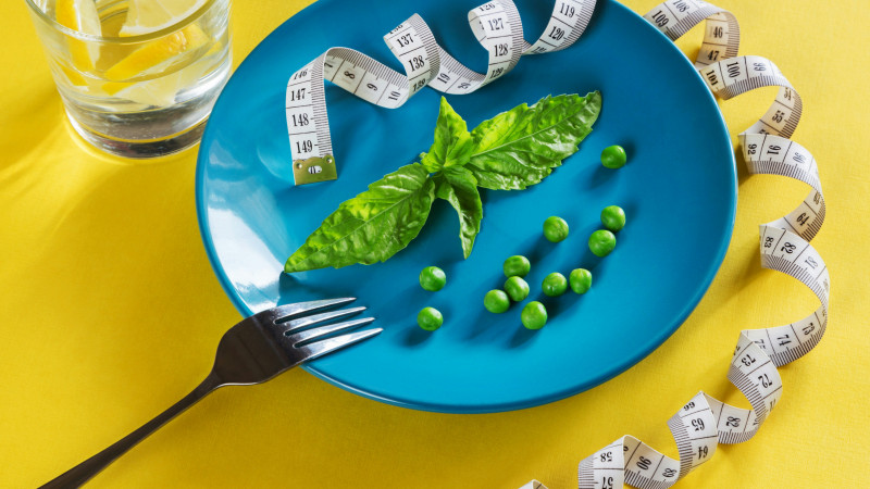 Diet blue plate with centimeter peas and basil