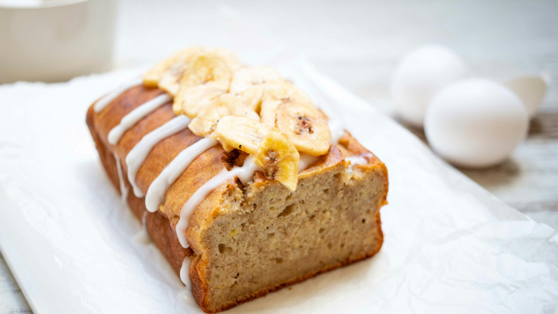a loaf of banana bread sitting on top of a white plate