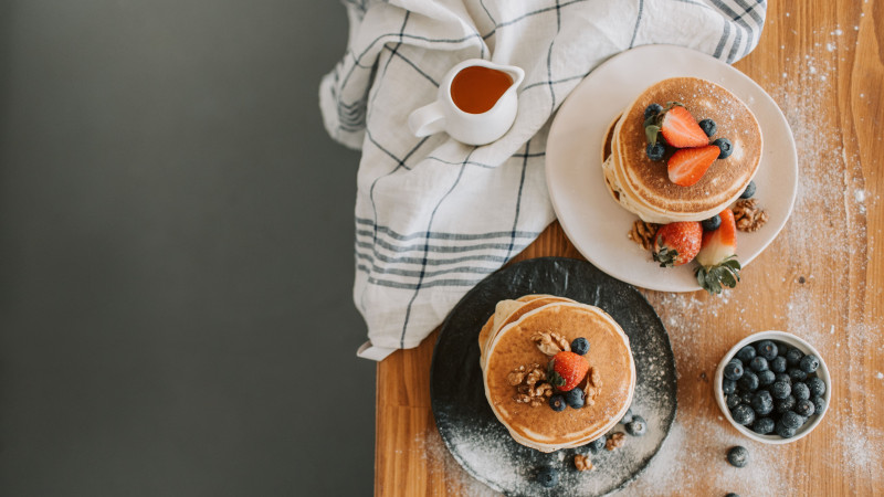 Vue aérienne de pancakes garnis de baies et de noix, parfaits pour l'inspiration du petit-déjeuner.
